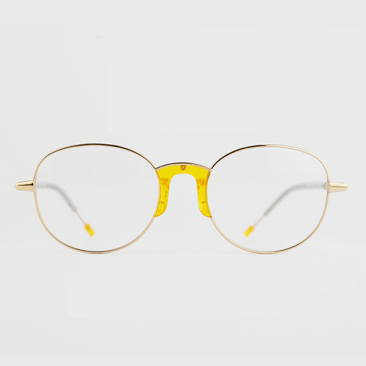 gold colour titanium round optical frame with yellow acetate nose pads and temple tips front
