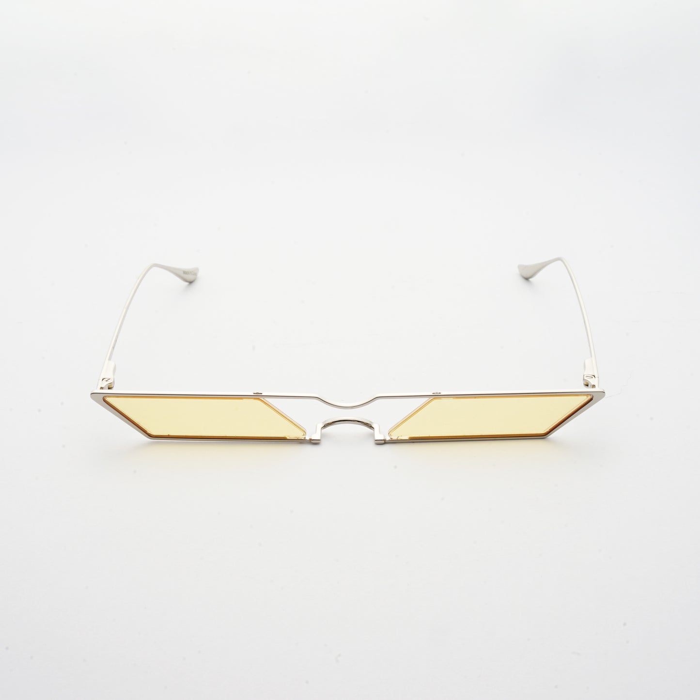 sunglasses with rhombus shaped light yellow lens and silver frames front