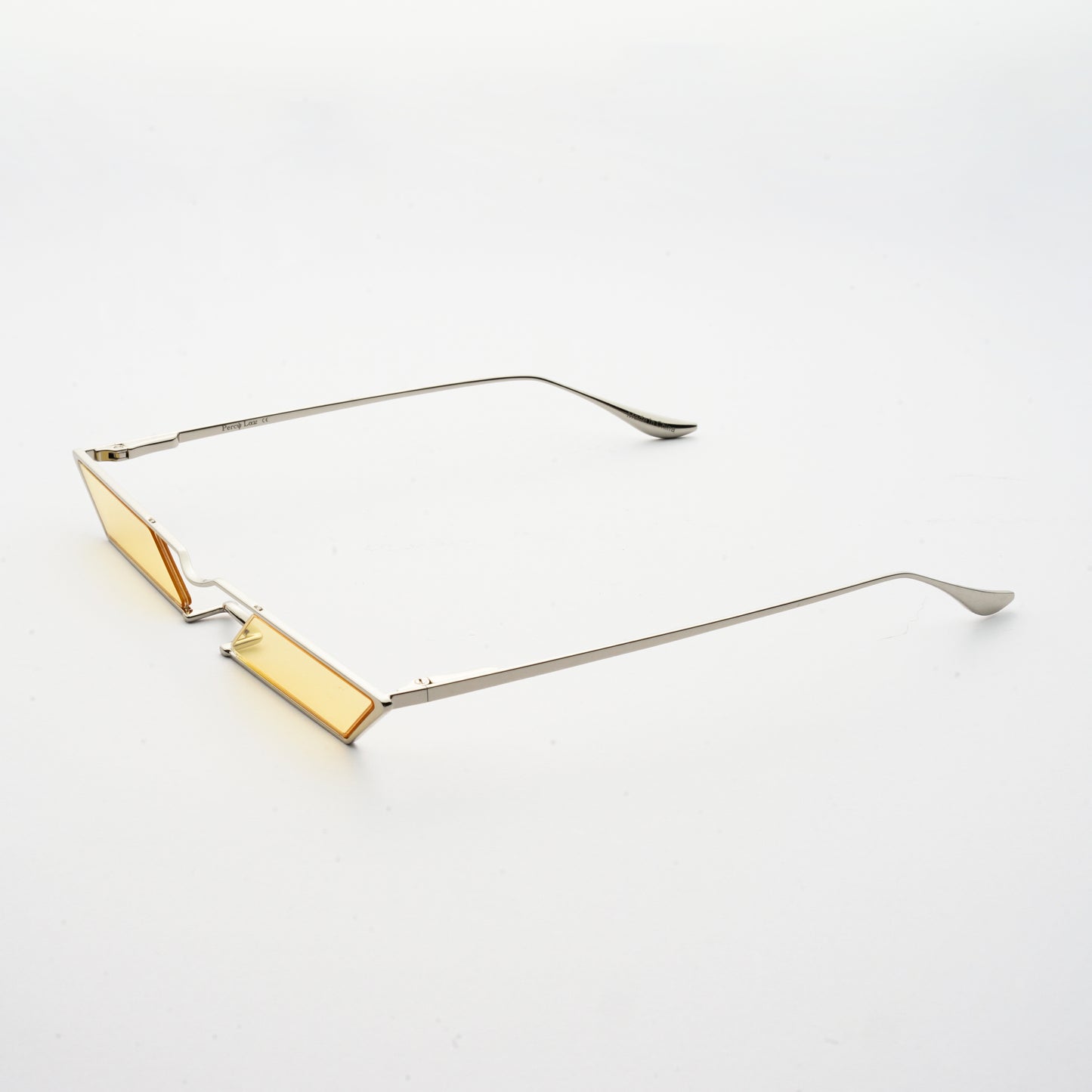 sunglasses with rhombus shaped light yellow lens and silver frames 45 angled