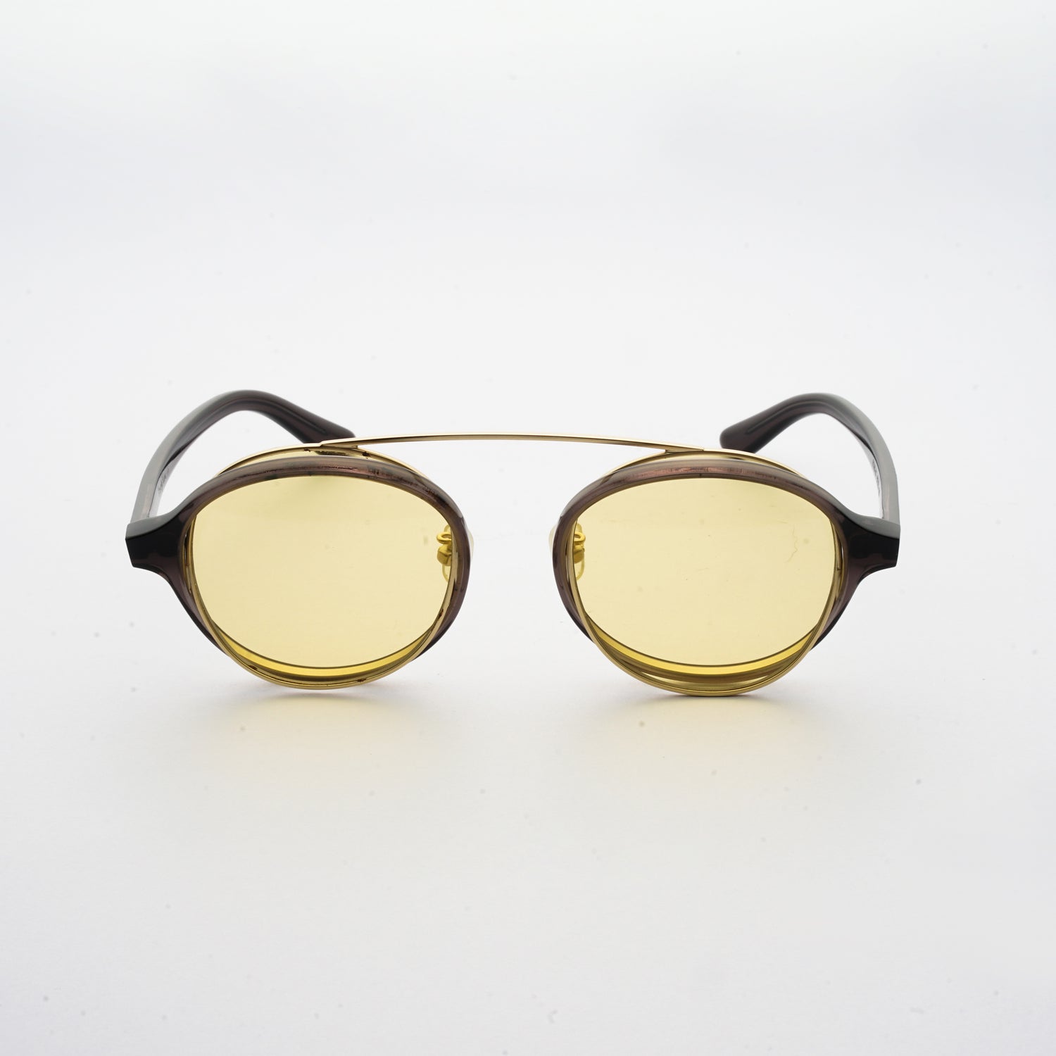 brown acetate round frames with crossed gold rims and light yellow nylon lens front