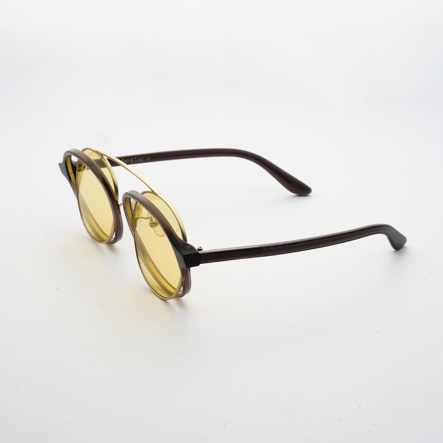 brown acetate round frames with crossed gold rims and light yellow nylon lens 45 angled