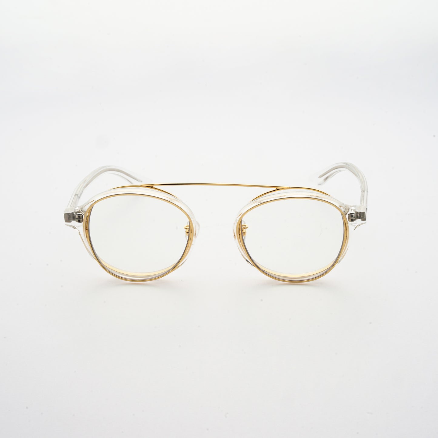 clear acetate round frames with crossed gold rims and clear nylon lens front