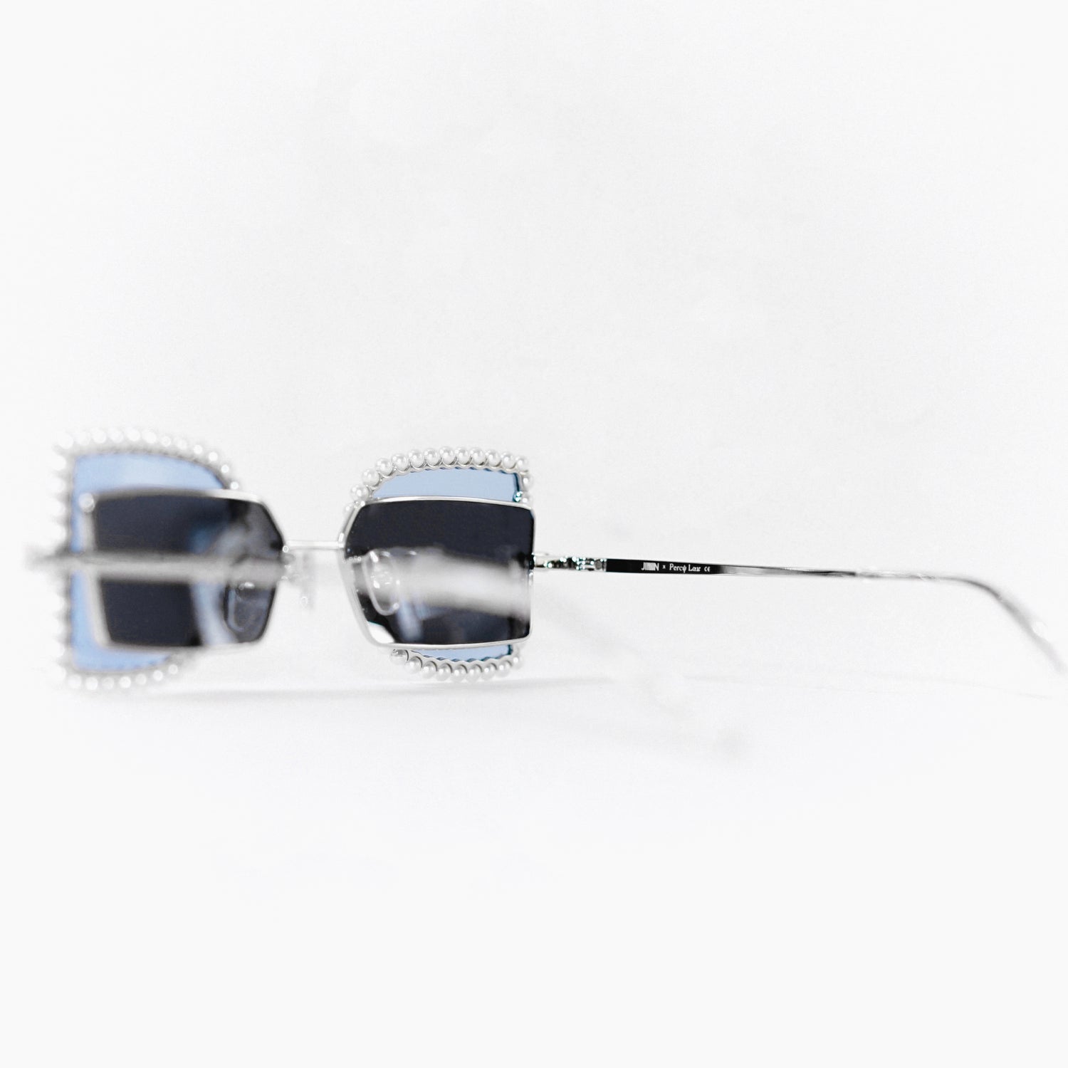 sunglasses with pearl rimmed window closed and blue polaroid lens 45 angled 2