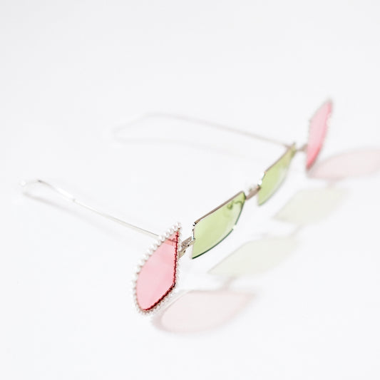 sunglasses with pearl rimmed pink windows opened and lime polaroid lens 45 angled