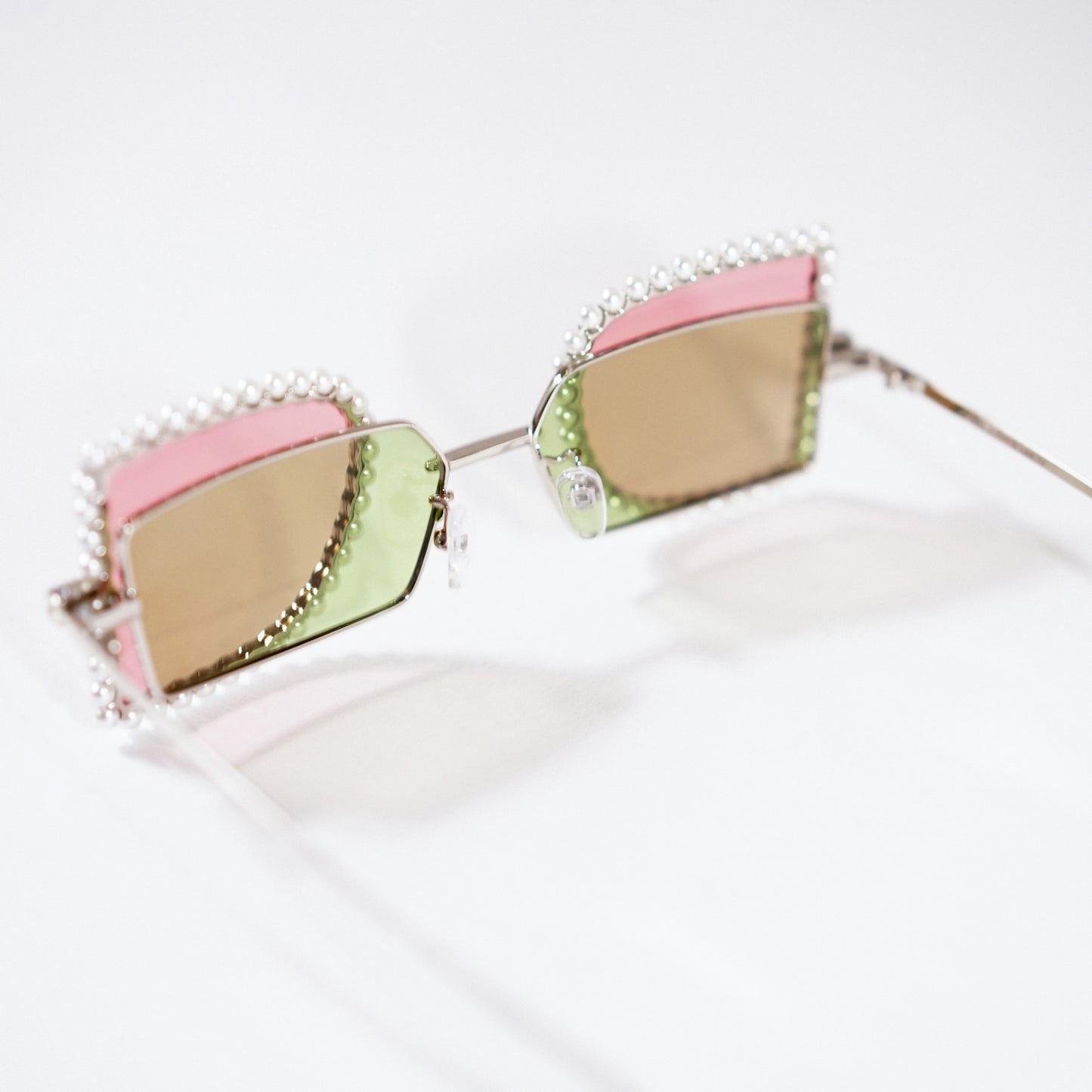 sunglasses with pearl rimmed pink windows closed and lime polaroid lens 45 angled 2