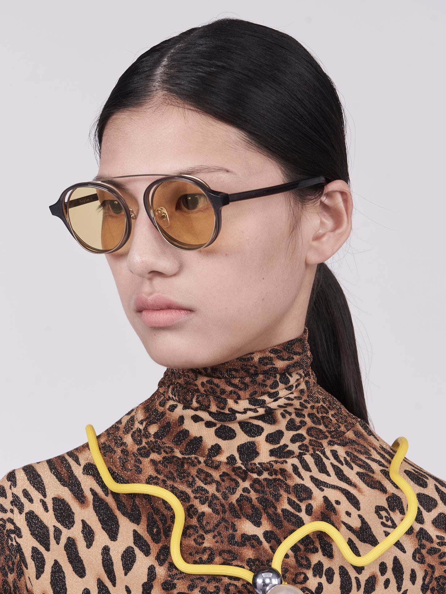 brown acetate round frames with crossed gold rims and light yellow nylon lens on model 45 angled
