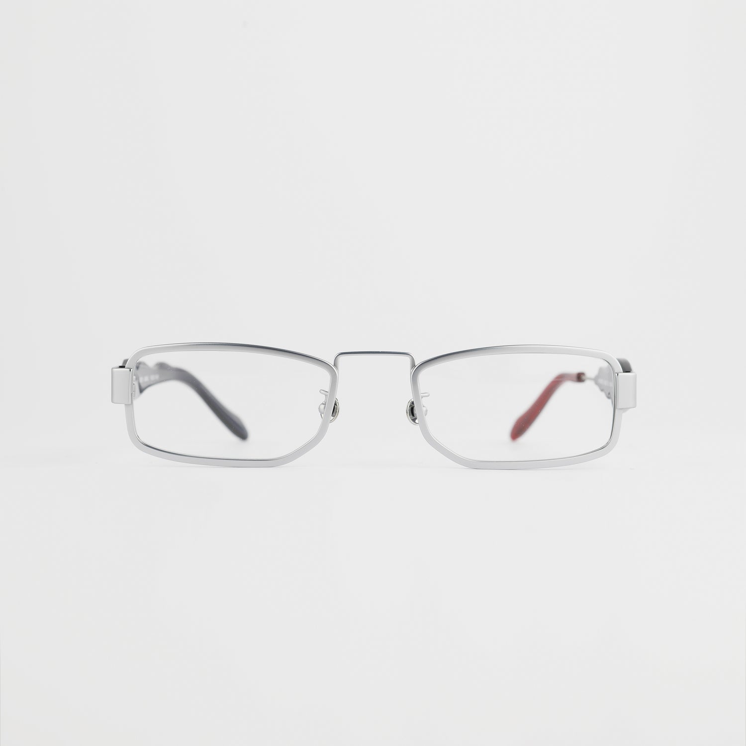 silver colour titanium rectangle optical frame with black acetate temples and a red tip front